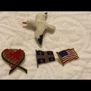Assorted brooches flags, bird and heart.
